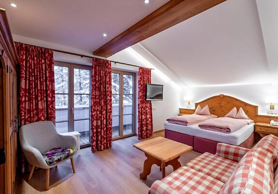 The bedroom of the Snow Princess Room, the spacious double bed and the wooden furnishings spread a country charm