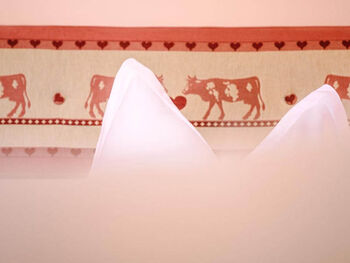 Bed decorated with cows.