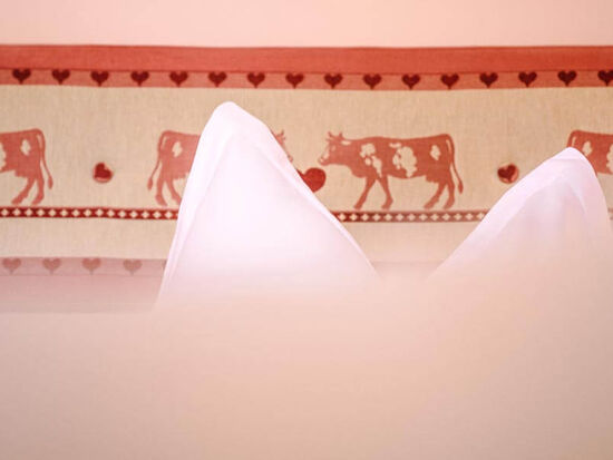 Bed decorated with cows.