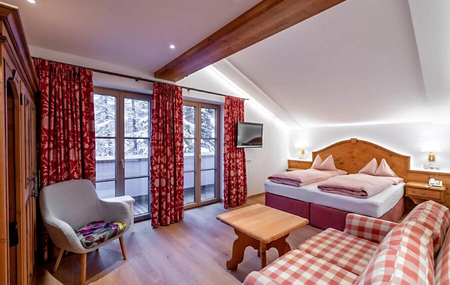 The bedroom of the Snow Princess Room, the spacious double bed and the wooden furnishings spread a country charm