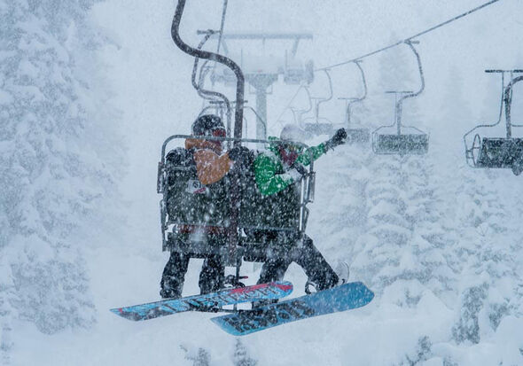 A couple on the snow lift in the Arlberg ski resort in Austria