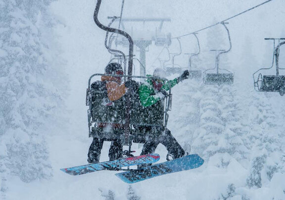 A couple on the snow lift in the Arlberg ski resort in Austria