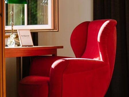 A red chair at the window