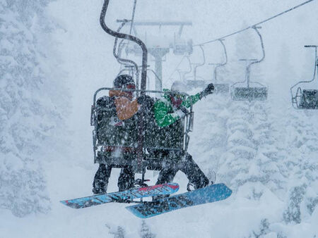 A couple on the snow lift in the Arlberg ski resort in Austria
