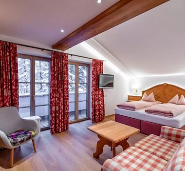 The bedroom of the Snow Princess Room, the spacious double bed and the wooden furnishings spread a country charm