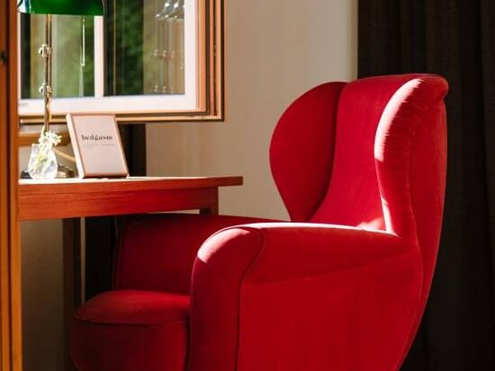 A red chair at the window