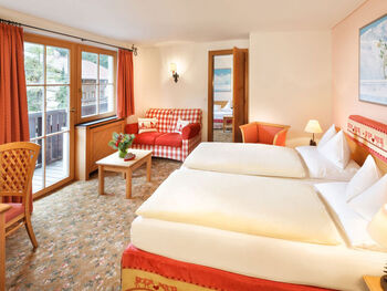 The double bed of the hotel room Snow Princess, with a view of the Alps from the window