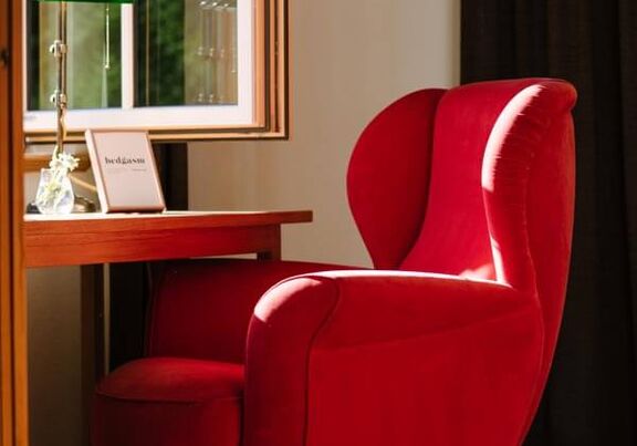 A red chair at the window