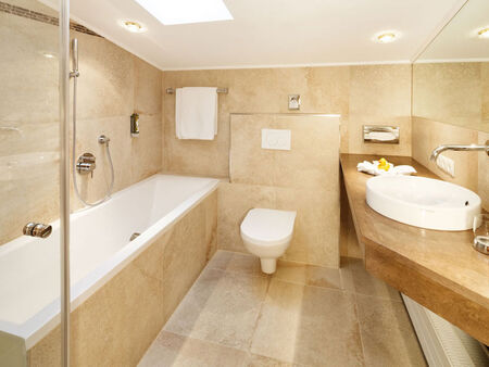 A bright bathroom with a bathtub, toilet and sink