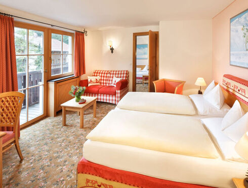 The double bed of the hotel room Snow Princess, with a view of the Alps from the window