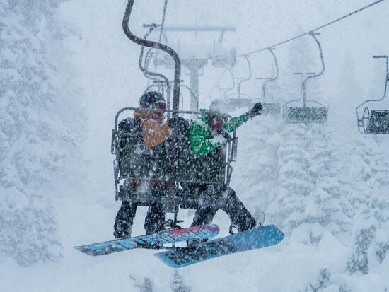 A couple on the snow lift in the Arlberg ski resort in Austria