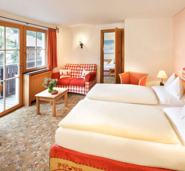 The double bed of the hotel room Snow Princess, with a view of the Alps from the window