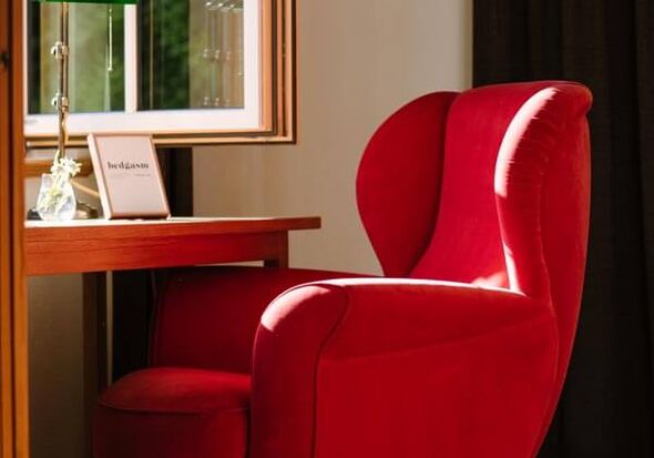 A red chair at the window