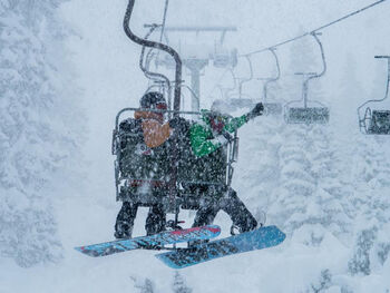 A couple on the snow lift in the Arlberg ski resort in Austria